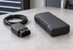 Generic disconnected diagnostic adapter cable beside an unbranded portable power unit
