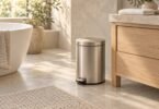 Illustration of a silver-toned pedal wastebasket beside a bathroom vanity