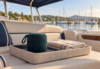 Conceptual illustration of an unbranded portable speaker and folded towel in a dry tray on a shaded boat bench.