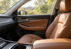 Tan leather front passenger seat and door trim in an empty car with a partly open side window