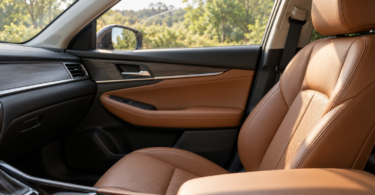 Tan leather front passenger seat and door trim in an empty car with a partly open side window