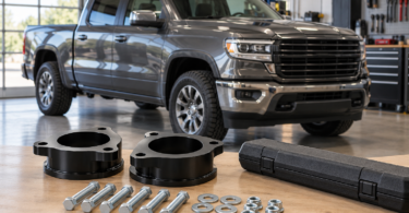 Generic suspension spacers and hardware on a workbench beside a parked pickup truck