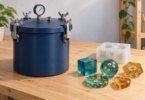 Illustration of an unbranded blue pressure vessel beside a white mold and translucent teal and amber resin shapes on a wooden workbench