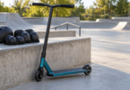 Conceptual image of an unbranded freestyle scooter beside a skatepark bench holding a helmet and knee and elbow pads.